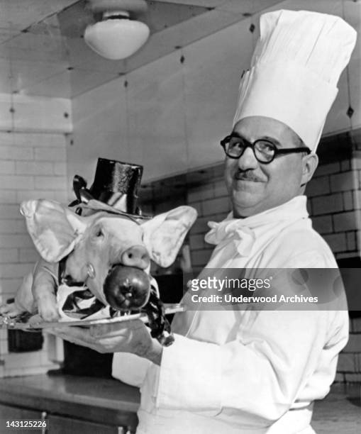 Roast pig, complete with top hat, tie, and tails, to be presented to Winston Churchill and his guests at the Savoy Hotel in London, London, England,...