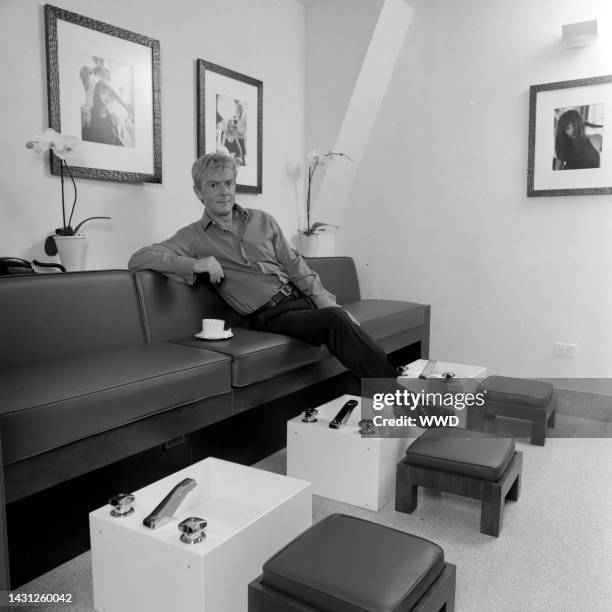 Hairstylist John Barrett poses for photographs.