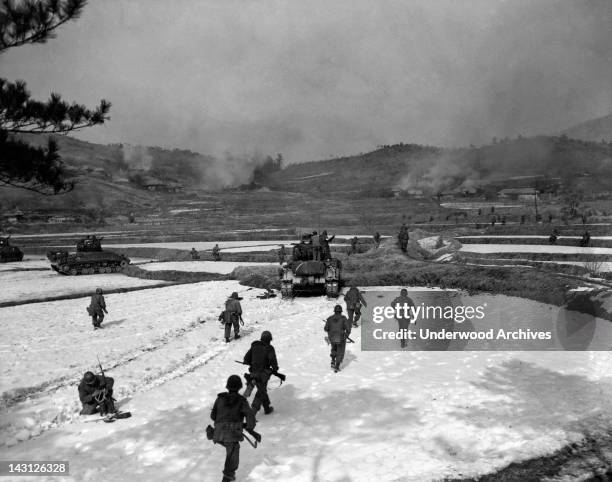 Soldiers of the United States 1st Calvary Division move out on an assault of a Communist held hill, Korea, February 4, 1951.