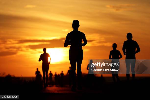 Athletes compete during the run portion of the Ironman World Championships on October 06, 2022 in Kailua Kona, Hawaii.