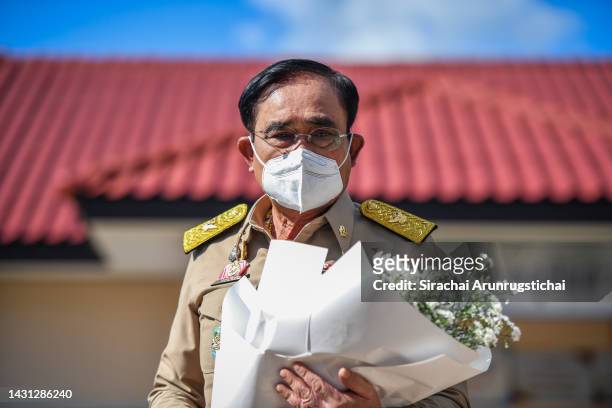 Thailand's Prime Minister Prayuth Chan-o-cha arrives to pay his respects to victims outside a child care center on October 07, 2022 in Uthai Sawan...
