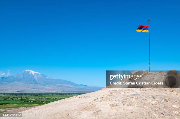 mount ararat and armenian flag in khor virap, armenia - armenia ストックフォトと画像