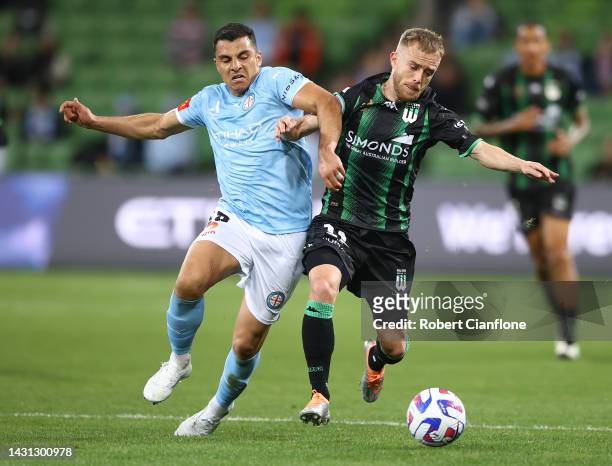 Connor Pain of Western United is challenged by Andrew Nabbout of Melbourne City during the round one A-League Men's match between Melbourne City and...