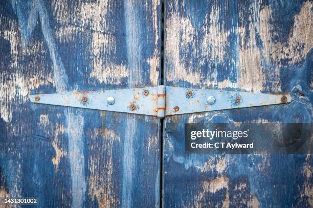 worn out garage door hinge and paint - hinge stock pictures, royalty-free photos & images