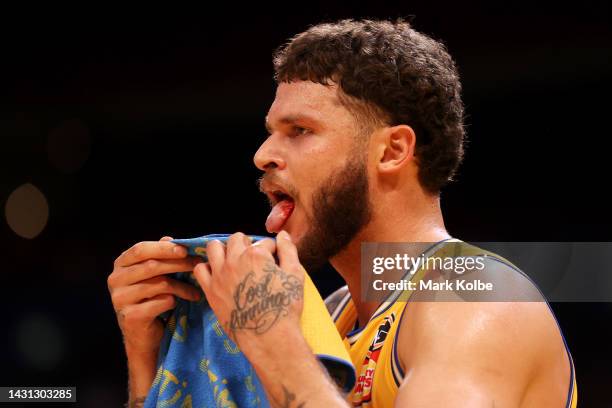 Tyler Johnson of the Bullets wipes away blood from his mouth during the round two NBL match between Sydney Kings and Brisbane Bullets at Qudos Bank...