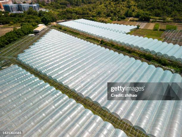 aerial view of film-covered farm greenhouse - film benefit stock pictures, royalty-free photos & images