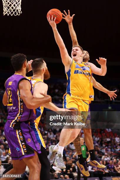 Harry Froling of the Bullets lays up a shot under pressure from Xavier Cooks of the Kings during the round two NBL match between Sydney Kings and...