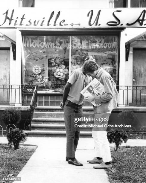 Peter Noone, lead singer of Herman's Hermits, chats with Stevie Wonder outside the offices of Motown Records in 1966 in Detroit, Michigan.