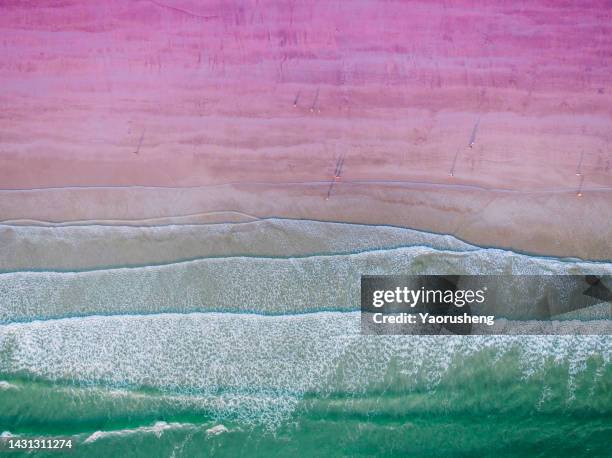 aerial view of  blue sea, waves and pink sand - briland stock-fotos und bilder