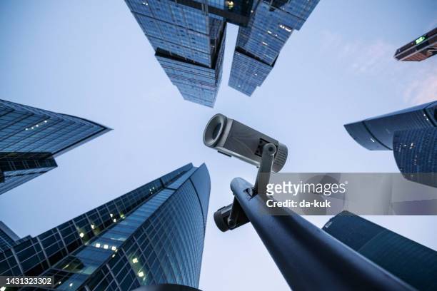 security camera monitoring system against modern skyscrapers - security camera view stock pictures, royalty-free photos & images