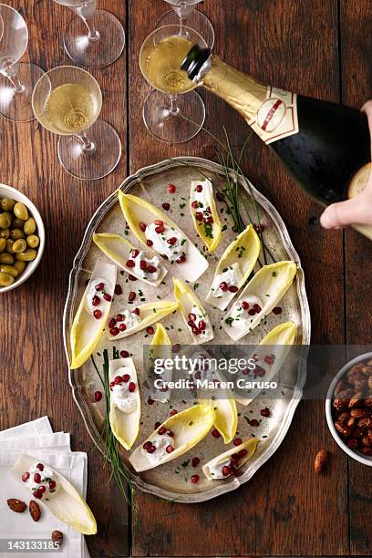 appetizer dishes and champagne being poured - häppchen stock-fotos und bilder