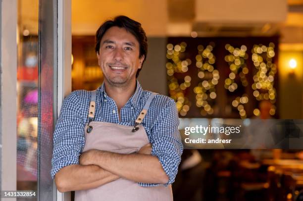 successful business owner standing on the door at his restaurant - front door open stock pictures, royalty-free photos & images