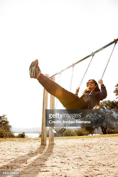 a female on a swing. - swing - fotografias e filmes do acervo