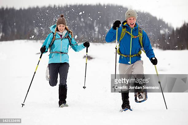 snow shoeing in the winter. - snowshoe stock pictures, royalty-free photos & images