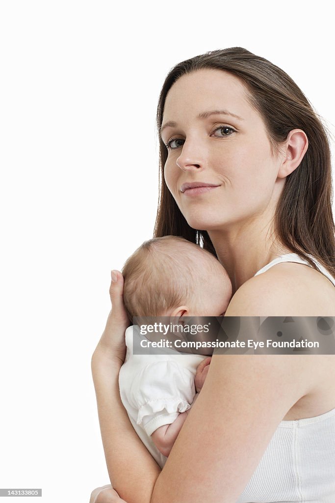 Portrait of mother holding baby