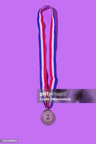 silver medal with the number 2, as the second classified, on a purple background. concept of winner, medals, honor, women's day, winning woman, working woman and sports competition. - trophy tour stock pictures, royalty-free photos & images