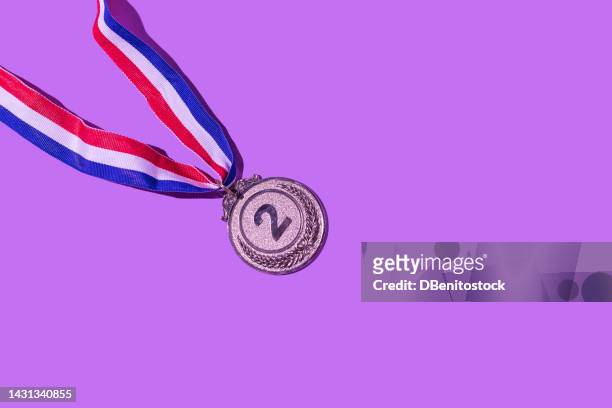 silver medal with the number 2, as the second classified, on a purple background. concept of winner, medals, honor, women's day, winning woman, working woman and sports competition. - trophy tour stock pictures, royalty-free photos & images