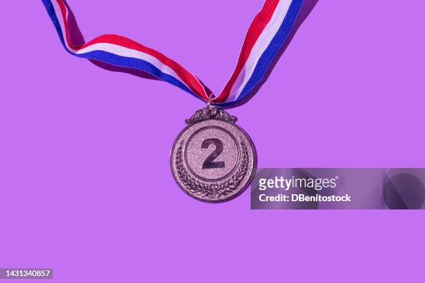 silver medal with the number 2, as the second classified, on a purple background. concept of winner, medals, honor, women's day, winning woman, working woman and sports competition. - medalha de prata - fotografias e filmes do acervo