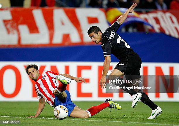 Diego Ribas of Atletico Madrid fights for the ball with Ricardo Costa of Valencia during the UEFA Europa League Semi Final first leg match between...
