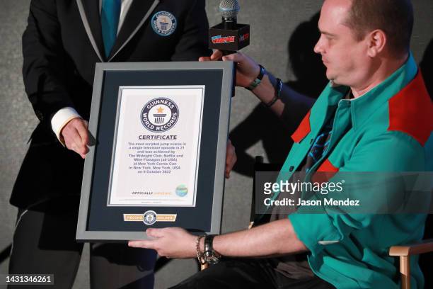 Andrew Glass of Guinness World Records awards Mike Flanagan onstage during Netflix's The Midnight Club at New York Comic Con on October 06, 2022 in...