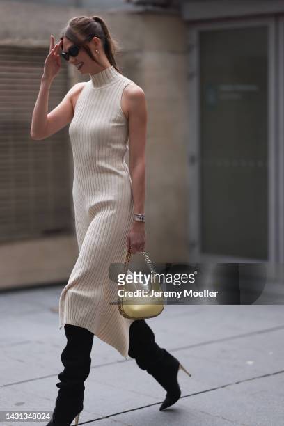 Karlie Kloss seen wearing a white dress and a yellow bag by Stella McCartney, outside Stella McCartney during Paris Fashion Week on October 03, 2022...