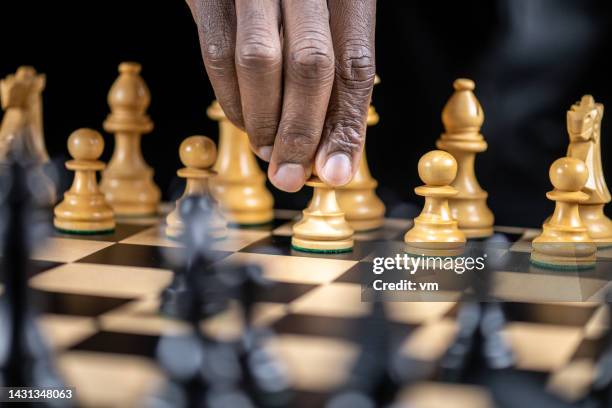 male hand moving with white pawn piece - risk management stock pictures, royalty-free photos & images