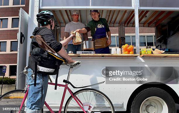 Clover Food Lab food truck owner Ayr Muir, right, serves fresh and healthy sandwiches at his truck near MIT in Cambridge, Thursday, March 26, 2009.