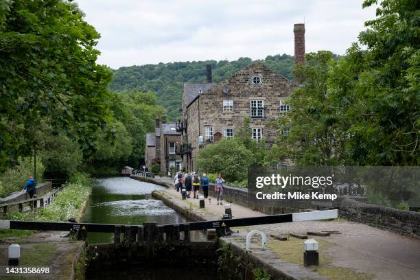 Scene of old industrial mill buildings along the Rochdale Canal on 7th June 2023 in Hebden Bridge, United Kingdom. In the 19th and 20th centuries the...