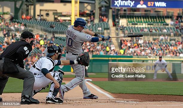 Michael Young of the Texas Rangers singles to left field scoring teammate Ian Kinsler in the first inning of the game against the Detroit Tigers at...