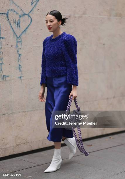 Irene Kim seen wearing a purple look with a matching Stella McCartney bag, outside Stella McCartney during Paris Fashion Week on October 03, 2022 in...