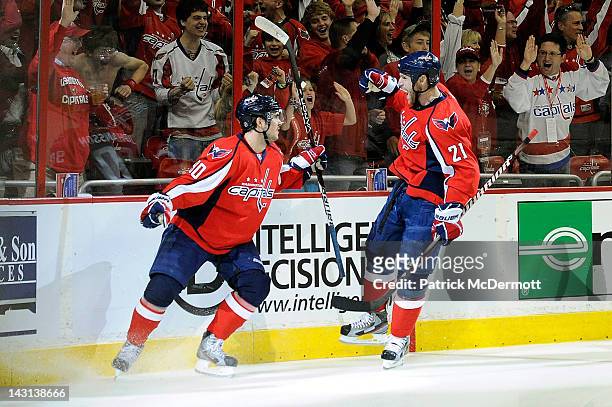 Marcus Johansson celebrates with Brooks Laich of the Washington Capitals after scoring a goal against the Boston Bruins in Game Four of the Eastern...