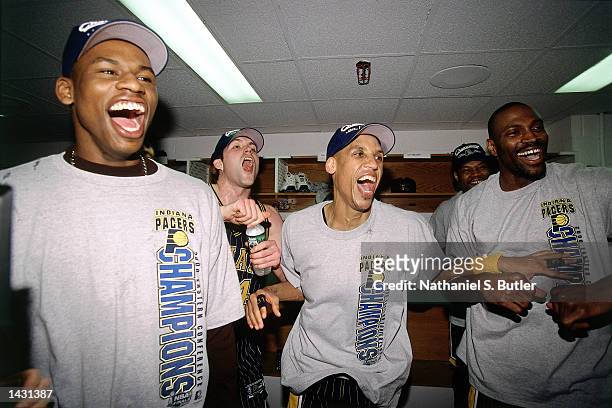 Al Harrington, Austin Croshere, Reggie Miller and Dale Davis of the Indiana Pacers celebrate in the lockerroom after winning game 6 of the Eastern...