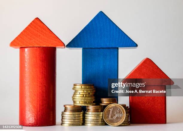 pile of money and small wooden house on a white background. - inflation euro stockfoto's en -beelden