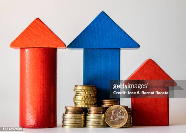 pile of money and small wooden house on a white background. - inflation euro stock pictures, royalty-free photos & images