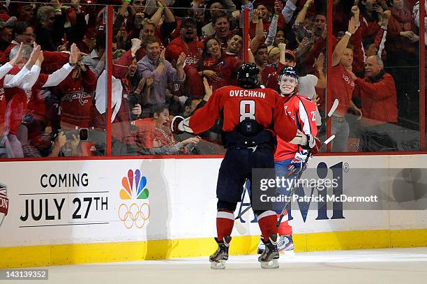 Alexander Semin celebrates with Alex Ovechkin of the Washington Capitals after scoring a goal against the Boston Bruins in Game Four of the Eastern...