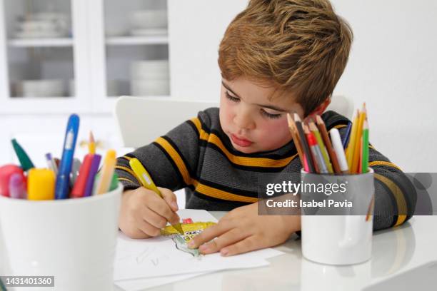 boy drawing on desk - coloring crayons stock pictures, royalty-free photos & images