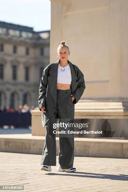 Guest wears a white ribbed cropped top from Louis Vuitton, a black and gray print pattern oversized blazer jacket from Louis Vuitton, matching black...