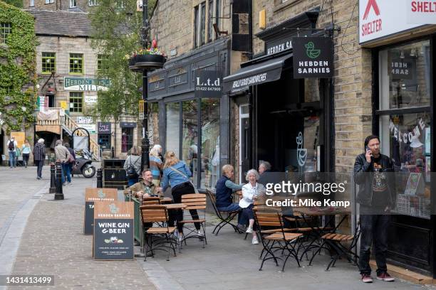 People outside pubs and cafes in the town centre on 7th June 2023 in Hebden Bridge, United Kingdom. Hebden Bridge is a market town in the Upper...