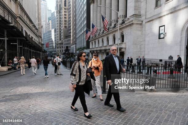 People walk along Wall Street by the New York Stock Exchange on October 07, 2022 in New York City. Stocks fell in early trading on Friday as new...