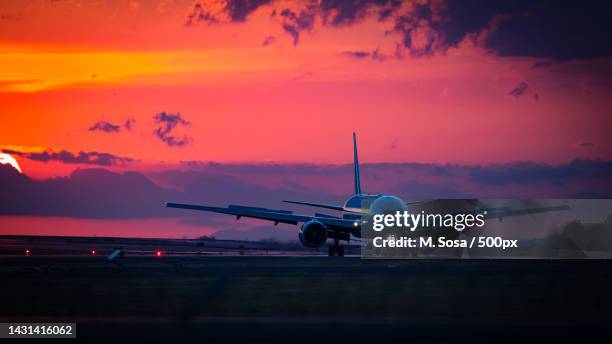 silhouette of airplane taking off at sunset,alajuela province,costa rica - aircraft taking off stock pictures, royalty-free photos & images