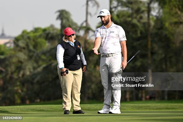 Jon Rahm of Spain talks to rules official on the 16th green during Day Two of the acciona Open de Espana presented by Madrid at Club de Campo Villa...