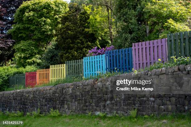 Brightly coloured fence around a home in rainbow flag colours on 7th June 2023 in Hebden Bridge, United Kingdom. Hebden Bridge is a market town in...