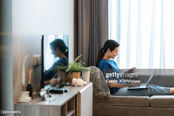 asian woman online purchase on laptop computer at home. - omnichannel retail stock pictures, royalty-free photos & images