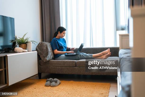 asian woman online purchase on laptop computer at home. - omnichannel retail stock pictures, royalty-free photos & images