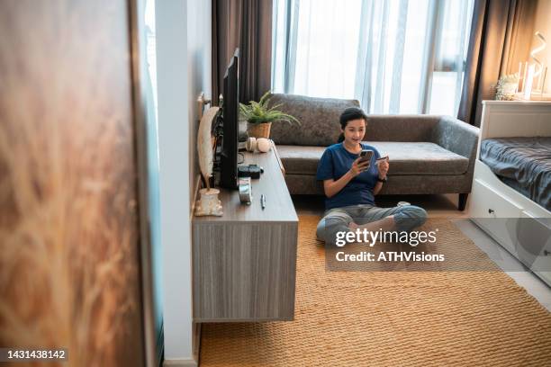 woman holding credit card online payment while shopping on mobile phone at home. - omnichannel retail stock pictures, royalty-free photos & images