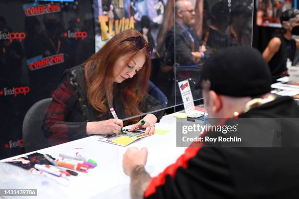 Cassandra Peterson signs memorabilia during New York Comic Con 2022 on October 07, 2022 in New York City.