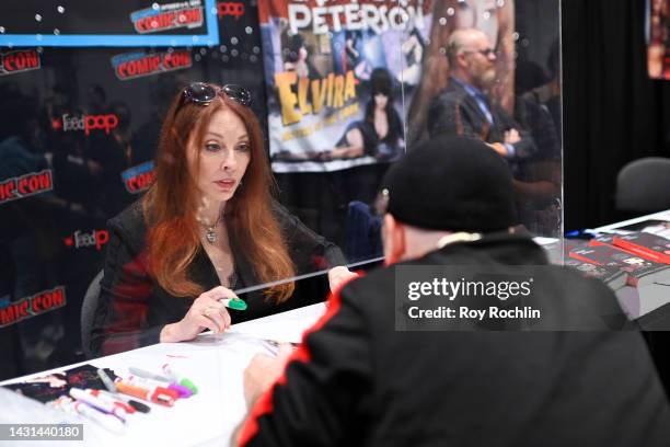 Cassandra Peterson speaks with fan during New York Comic Con 2022 on October 07, 2022 in New York City.