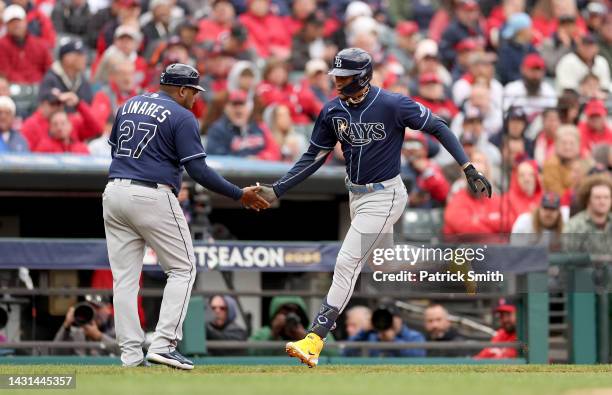 Jose Siri of the Tampa Bay Rays celebrates with third base coach Rodney Linares after hitting a home run in the sixth inning against the Cleveland...