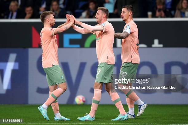 Marvin Ducksch of Werder Bremen celebrates scoring his teams first goal of the game with Marco Friedl and Mitchell Weiser during the Bundesliga match...