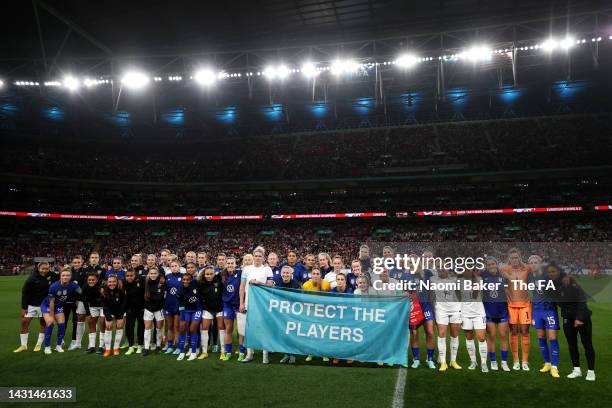 Players of England and USA pose for a photograph with a banner reading 'Protect the Players' prior to the Women's International Friendly match...